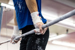 Male gymnast on high bar with Reisport® Men's Hyper Protec High Bar Grips on hands