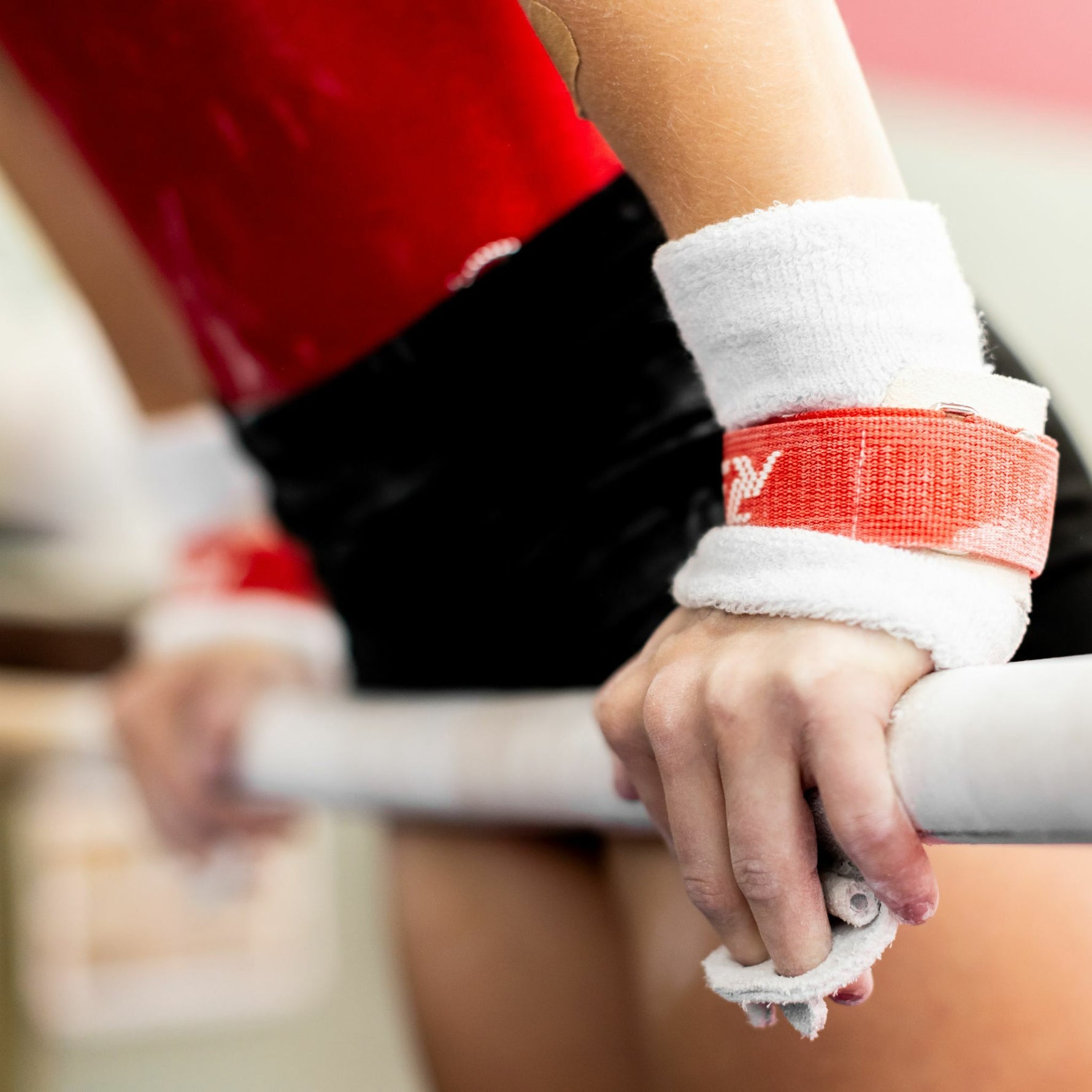 Female gymnast on uneven bars with Reisport® Women's Uneven Bar Grips - Hook/Loop