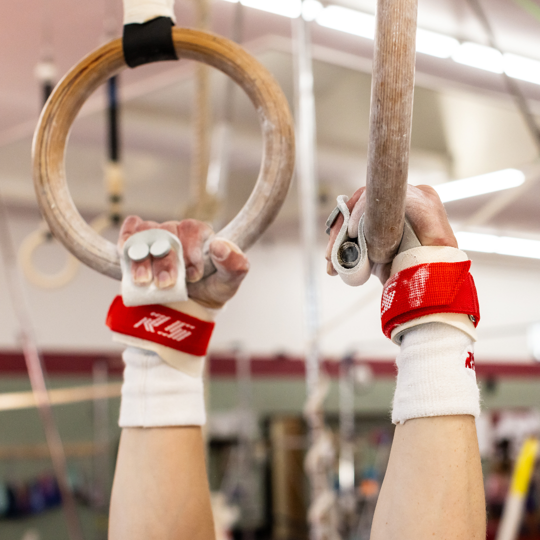 Male gymnast on rings with Reisport® Men's Ring Grips - Hook/Loop on hands