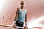 girl with Gibson Just Right Uneven Bar double buckle grips holding bar