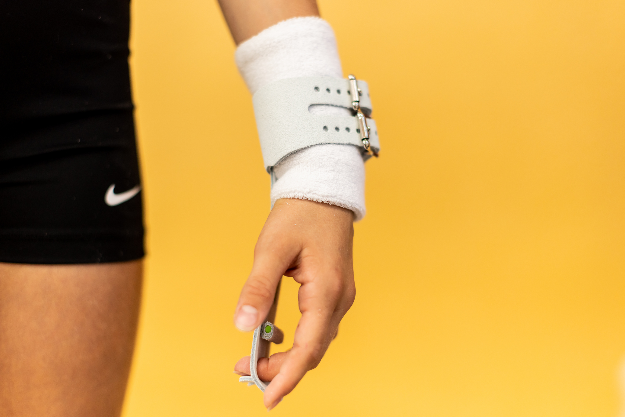 Gibson Just Right Uneven Bar double buckle grip on hand on yellow background