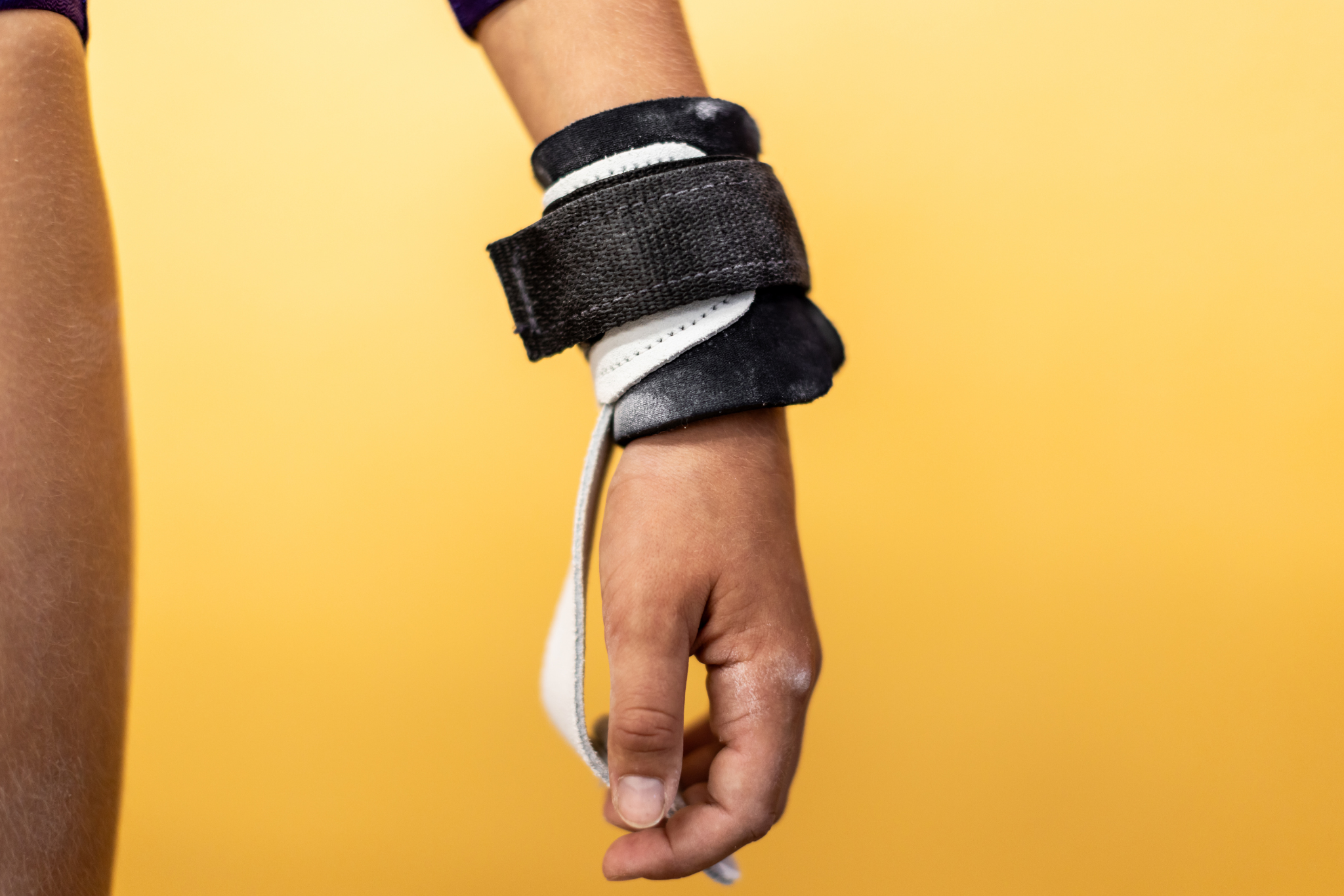 Gibson Just Right Uneven Bar Neo Grips on hand on yellow background