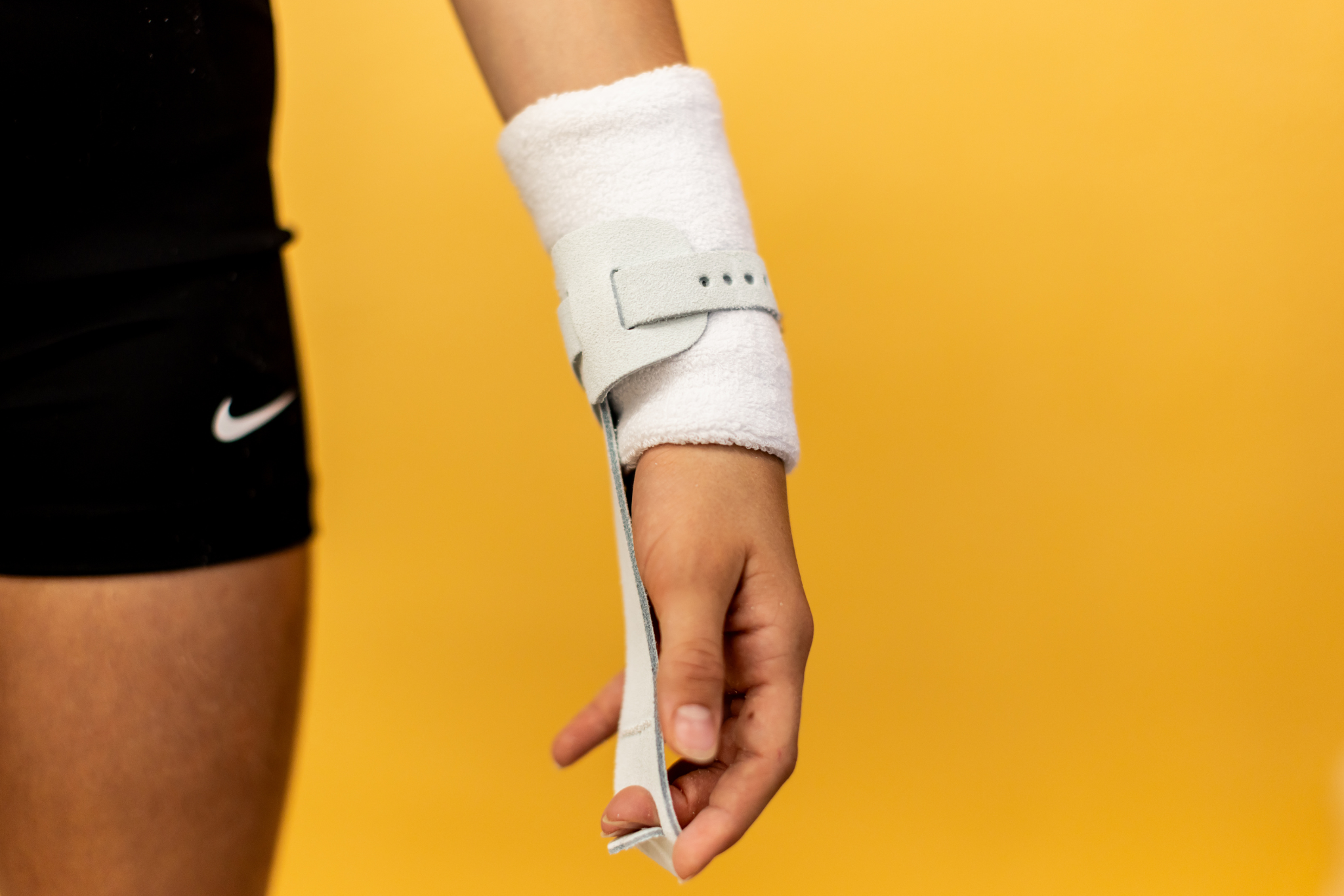 Gibson Just Right Uneven Bar single buckle grip on hand on yellow background