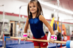 young girl wearing pink Gibson Rainbow grips holding bar
