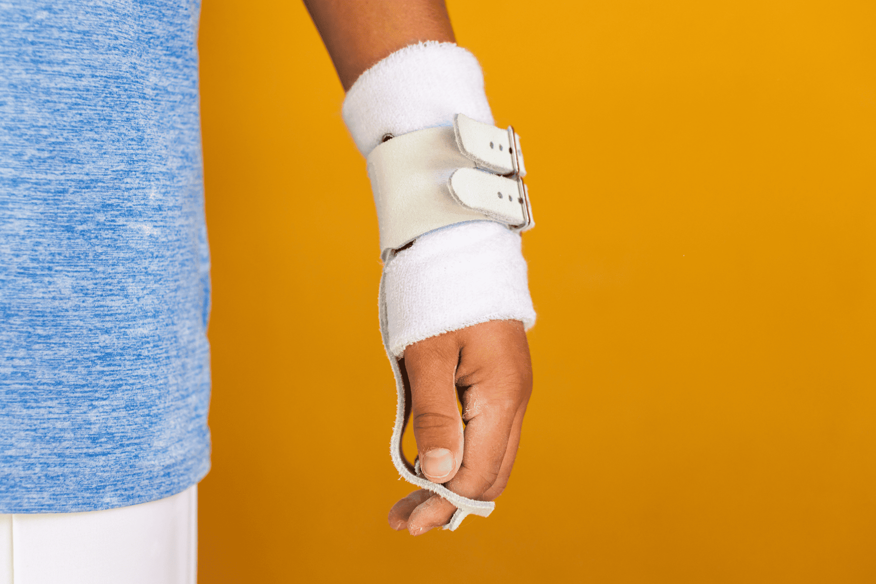 Gibson Summit High Bar double buckle grips on hand on yellow background