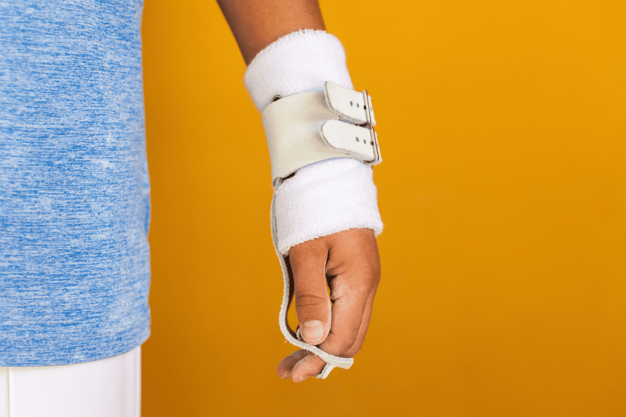 Gibson Summit High Bar double buckle grips on hand on yellow background