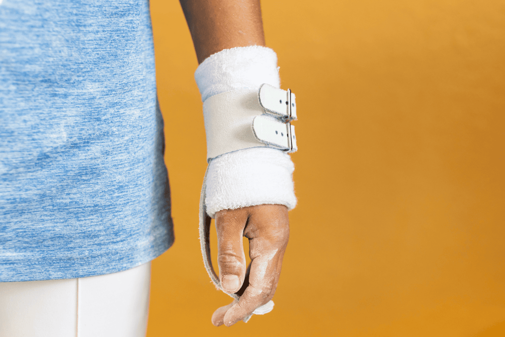 Gibson Summit Ring double buckle grips on hand on yellow background