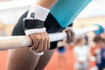 Gibson Summit Uneven Bar hook-and-loop grips on girl holding gymnastics bar